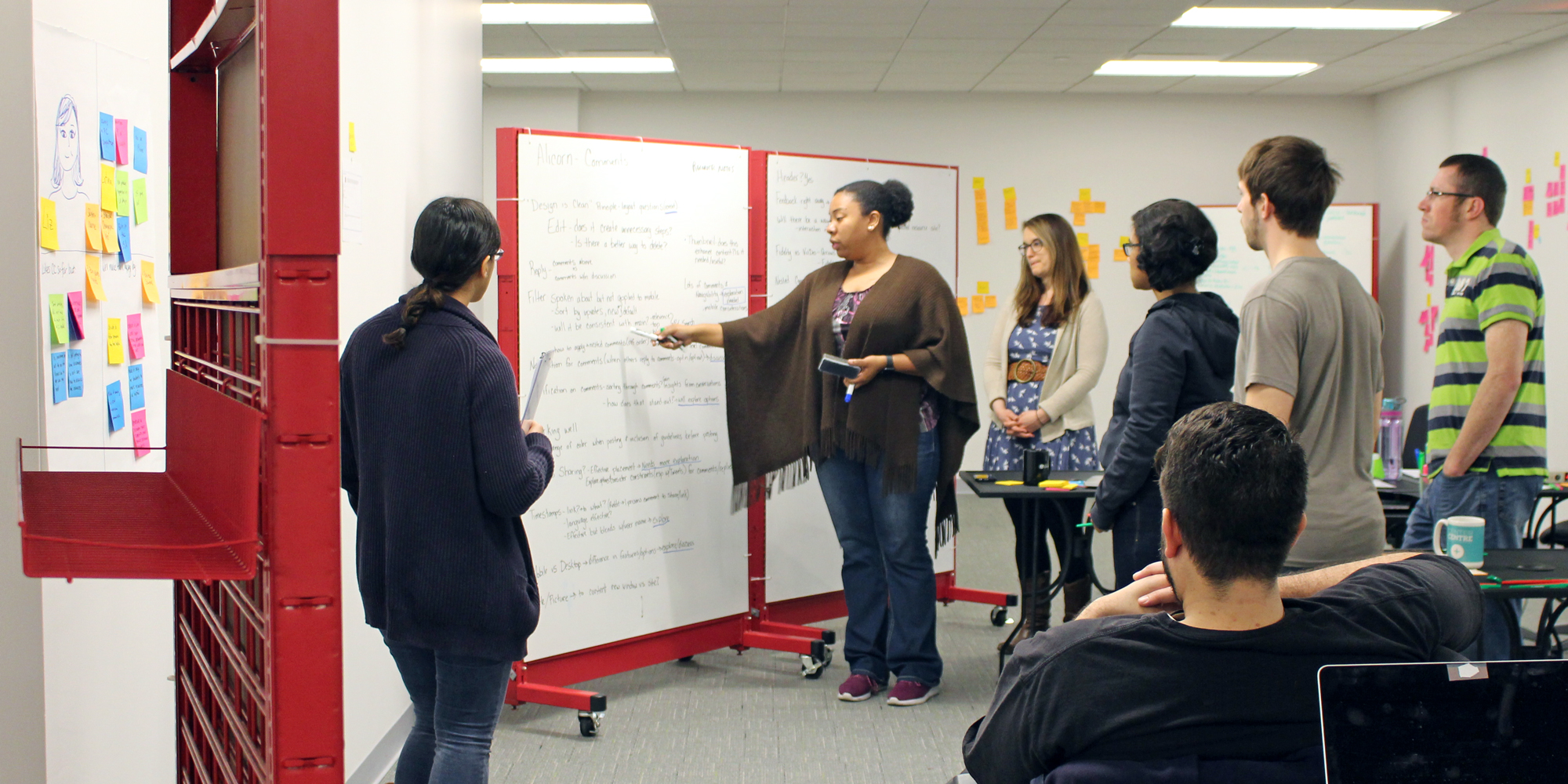 Photo of students critiquing work during a design studio.